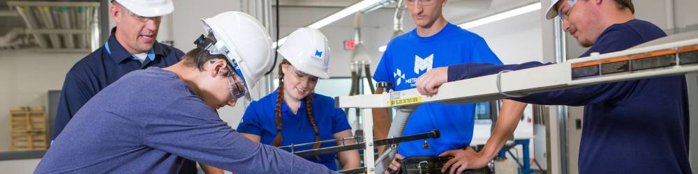 A group of students and instructors in hard hats