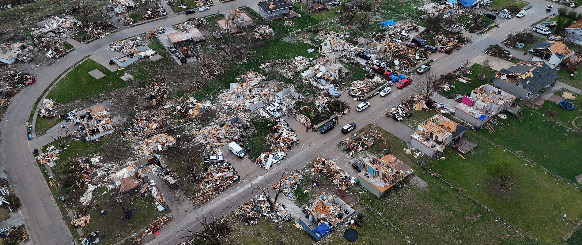Aerial drone photo surveying damage in a neighborhood after a tornado